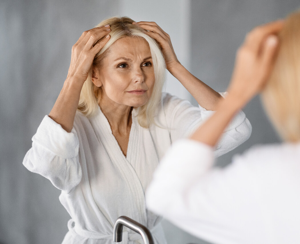 grey-hair-upset-mature-woman-looking-in-mirror-at-2025-03-18-16-39-33-utc (1)