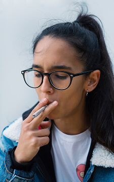 young-woman-lighting-cigarette-2023-11-27-04-59-03-utc (1)